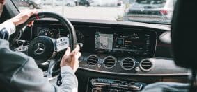 person in gray long sleeve shirt driving car