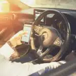 person holding black and silver steering wheel