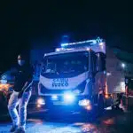 a man standing next to a truck on a street